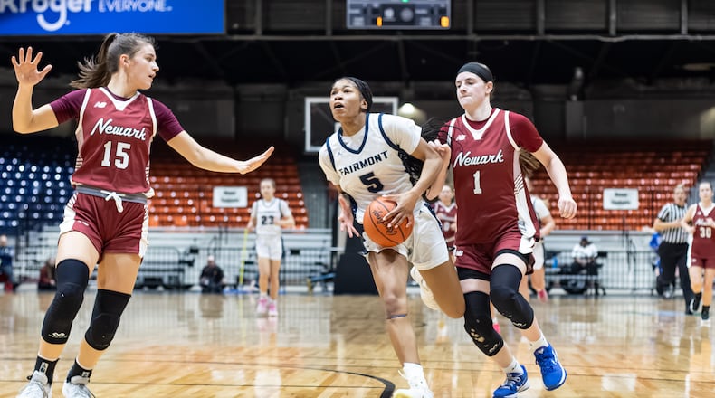 Fairmont High School senior Kaylah Thornton drives past Newark juniors Emma Quackenbush (1) and Calli Geller (15) during their Division I regional semifinal game on Tuesday, March 3 at the Ohio Expo Center's Taft Coliseum. MICHAEL COOPER / STAFF