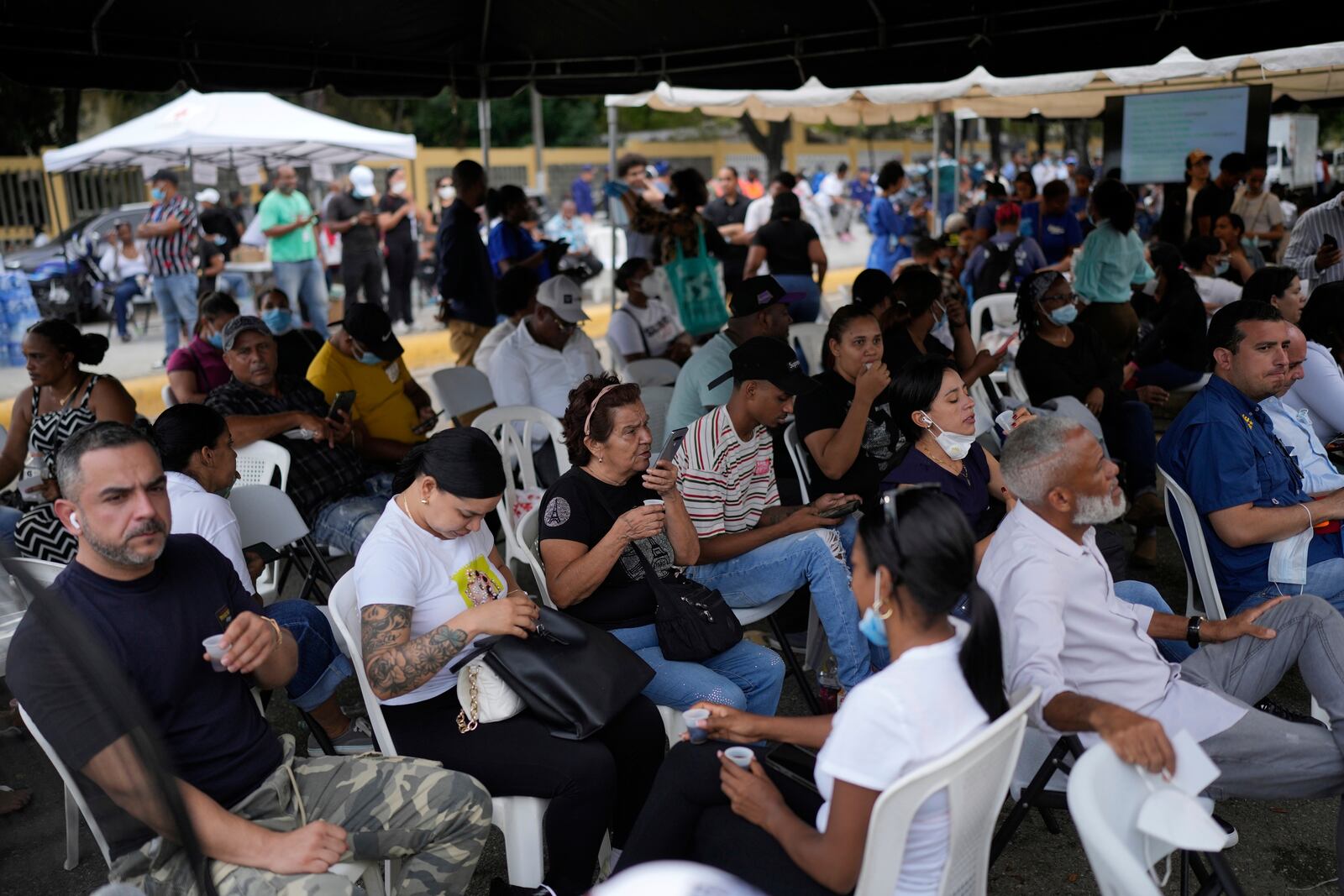 Family members wait to receive the remains of their loved one who died at the Jet Set nightclub days after its roof collapsed, killing more than 200 people, at the National Institute of Forensic Pathology in Santo Domingo, Dominican Republic, Friday, April 11, 2025. (AP Photo/Matias Delacroix)