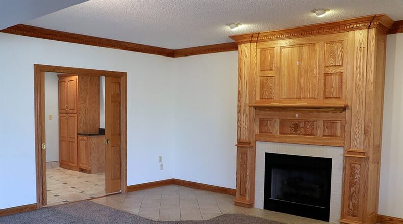 The lower level has been finished into a recreation room and family room. A detailed oak mantel surrounds a gas fireplace, which is the centerpiece to the family room setting.