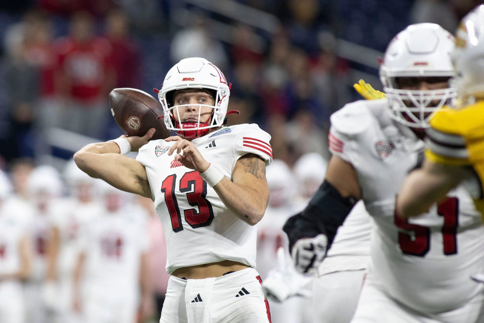 Miami (Ohio) quarterback Thomas Gotkowski (13) throws the ball against Western Michigan in the first half of the Mid-American Conference championship NCAA college football game on Saturday, Dec. 6, 2025, in Detroit. (Abra Richardson /Ann Arbor News via AP)