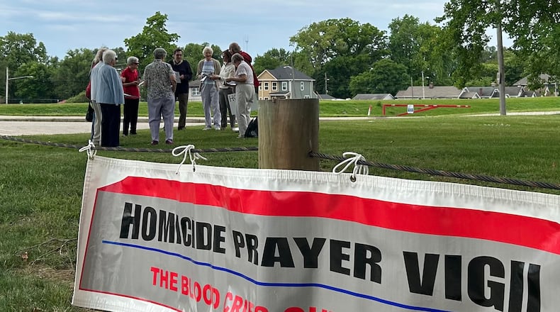 A group of Dayton-area residents hold a prayer vigil for homicide victims June 8, 2024, at McIntosh/Riverview Park in Dayton. JEREMY P. KELLEY / STAFF