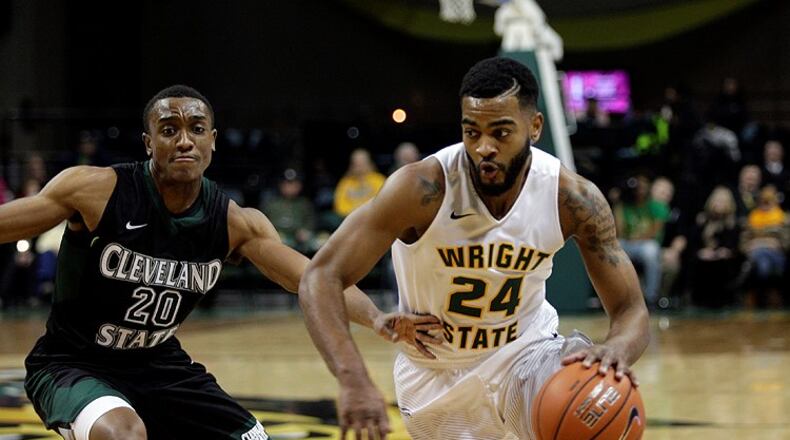 Wright State’s Mark Alstork tries to maneuver past Cleveland State’s Bobby Word during their game Thursday night at the Nutter Center. TIM ZECHAR / CONTRIBUTED