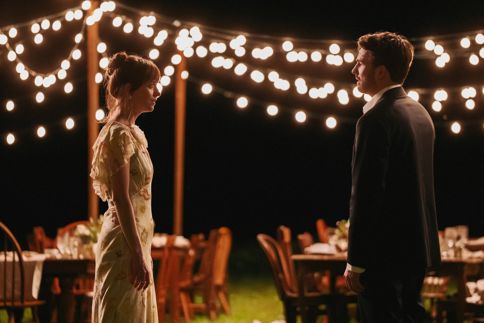 This image released by A24 shows Dakota Johnson, left, and Chris Evans in a scene from "Materialists." (A24 via AP)