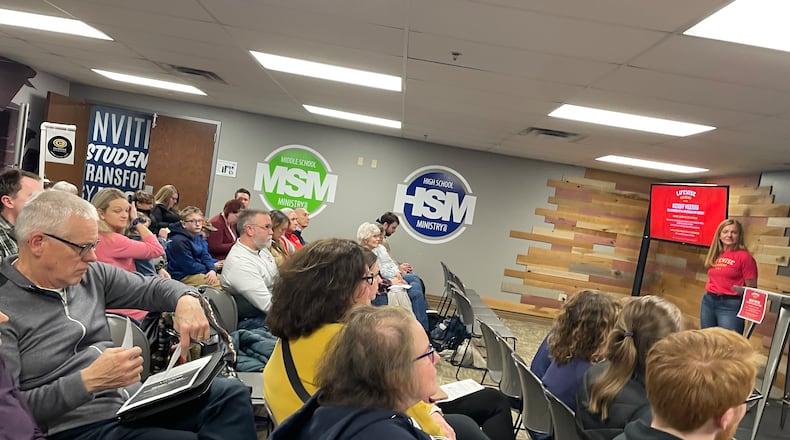 A First Baptist Church of Kettering member (at the far right near the red screen) was one of the presenters during a Jan. 25 meeting about LifeWise Academy school religion programs for residents of the Centerville and Kettering school districts. NICK BLIZZARD/STAFF