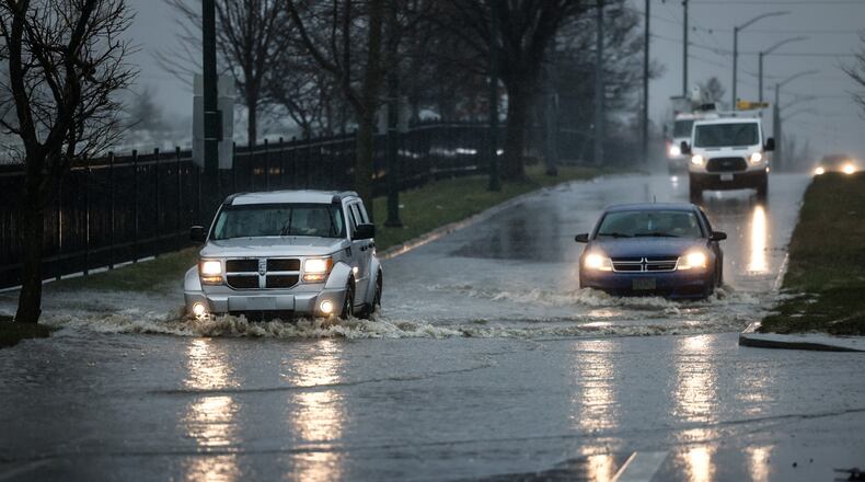 Motorists roll through deep water on southbound Gettysburg Ave. in front of the Dayton National Cemetery Friday March 3, 2023. Since this photo was taken, southbound has closed. JIM NOELKER/STAFF