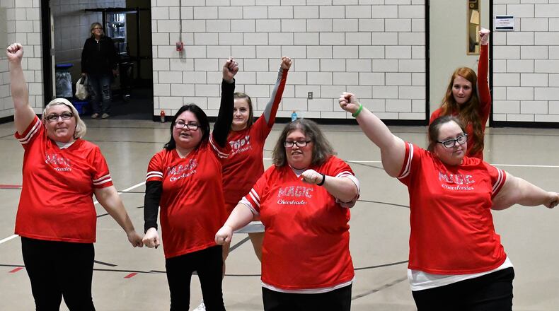 Cheerleaders from Troy High School (back row) take to the floor at Riverside (Miami County Board of Developmental Disabilities) with the Riverside Magic cheerleaders (front) for the annual Spirit Night basketball game on March 1. CONTRIBUTED