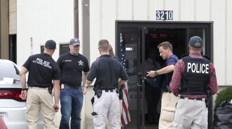 Law enforcement officers gather outside U.S. Beef in Fairfield, Wednesday, Aug. 26, 2015. Dozens of people were targeted for arrest in the Fairfield and Hamilton areas as part of a lengthy food stamp fraud investigation that included federal, state and local law enforcement agencies. GREG LYNCH / STAFF