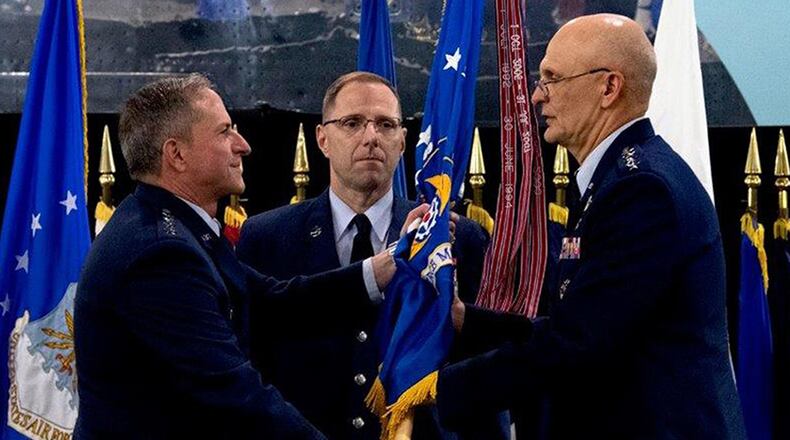 Air Force Chief of Staff Gen. David L. Goldfein passes the flag to Gen. Arnold W. Bunch Jr. as Bunch assumes command of Air Force Materiel Command during a ceremony at the National Museum of the U.S. Air Force May 31. Bunch takes command of AFMC after serving as the deputy to the Assistant Secretary of the Air Force for Acquisition, Technology, and Logistics at the Pentagon. (U.S. Air Force photo/Scott M. Ash)