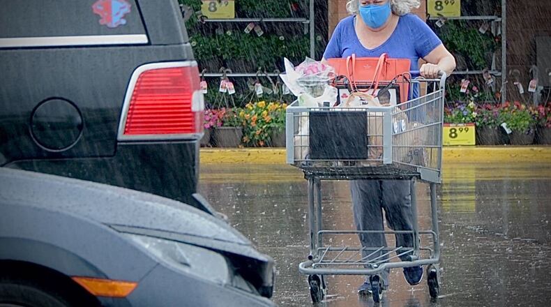 It may not have been the best day to go shopping without an umbrella or rain jacket Thursday, April 29, 2021, at the Kroger on Dorothy Lane in Kettering. MARSHALL GORBY\STAFF