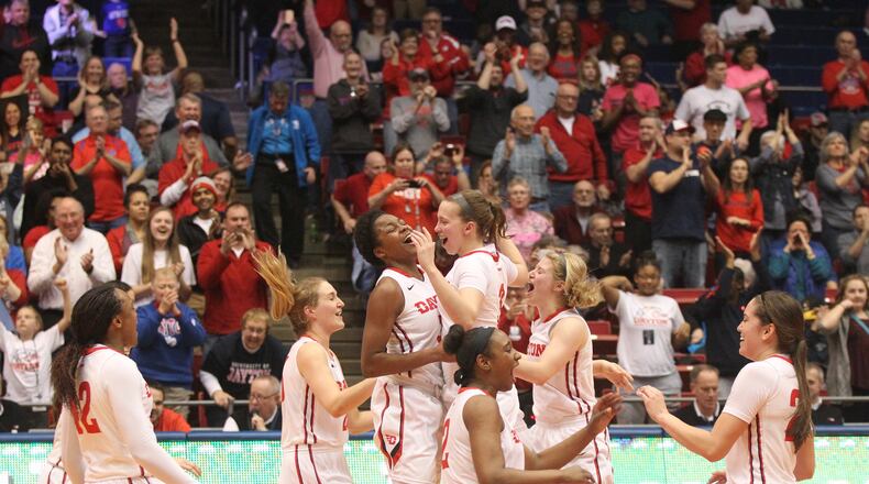 Dayton celebrate after a victory against Saint Louis on Wednesday, Feb. 22, 2017, at UD Arena. David Jablonski/Staff