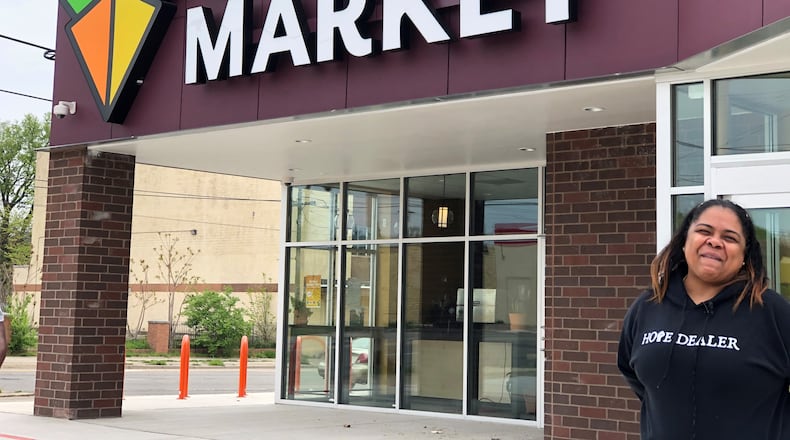 Kenya Baker, Gem City Market community engagement director, stands outside the marker on Wednesday, April 28, 2021. After years of planning and work, the Gem City Market is announcing its grand opening. STAFF / CORY FROLIK