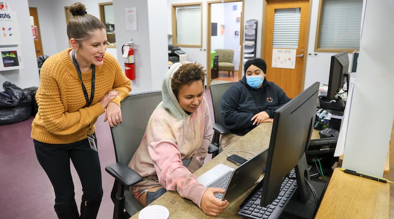 From left to right, Daybreak CEO Courtney Patel, Paris Wood and residential specialist Raquel Fernandez laugh while Wood comments on a video she's watching on Tuesday, Dec. 30 at Daybreak's emergency shelter. The organization, which provides refuge for runaway and homeless children and young adults, is grappling with a loss of some funding due to governmental cuts. BRYANT BILLING/STAFF