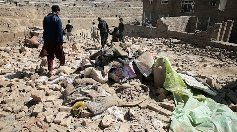 Residents inspect the site of a strike in Kabul, Afghanistan, Friday, March 13, 2026. (AP Photo/Barackatullah Popal)