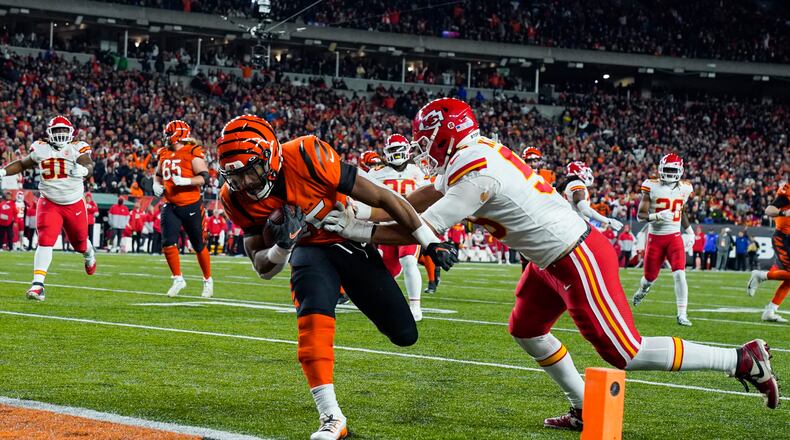 Cincinnati Bengals running back Chris Evans (25) runs in for a touchdown past Kansas City Chiefs defensive end George Karlaftis (56) in the second half of an NFL football game in Cincinnati, Fla., Sunday, Dec. 4, 2022. (AP Photo/Jeff Dean)