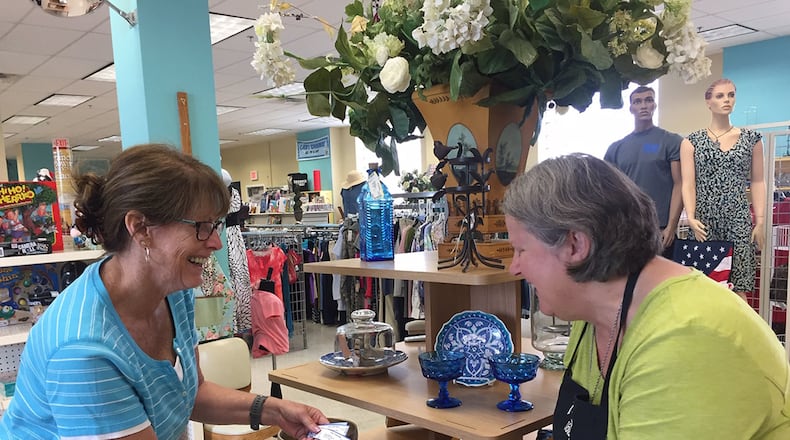 Officers’ Spouses’ Club volunteers Caroline Bunch (left) and De McMurry prepare a display of home decor items in preparation for the Wright-Patterson Air Force Base thrift shop’s Aug. 16 reopening. (Skywrighter photo/Amy Rollins)