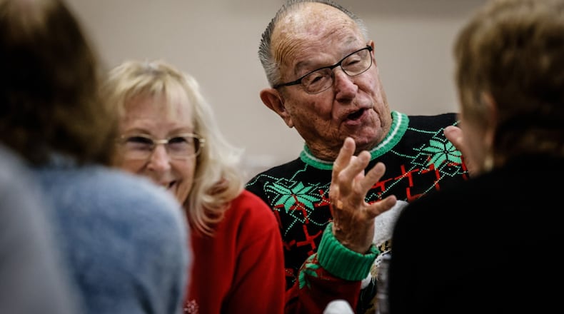 Joy and Paul Moyer enjoy conversation with other seniors at the Fairborn Senior Center Monday December 11, 2023. JIM NOELKER/STAFF
