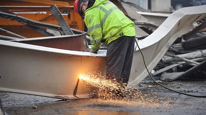 A worker at work on a downtown project to build a hotel near Day Air Field.