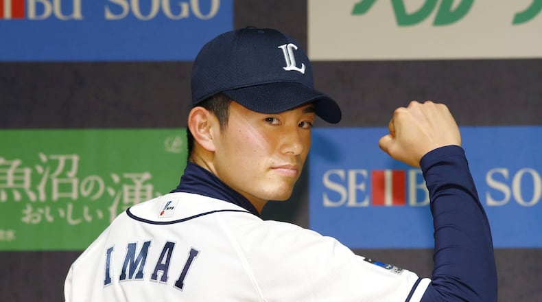 FILE - Tatsuya Imai wears Seibu Lions' jersey during a news conference in Tokorozawa, Saitama prefecture, Japan, on Dec. 9, 2016. (Kyodo News via AP, File)