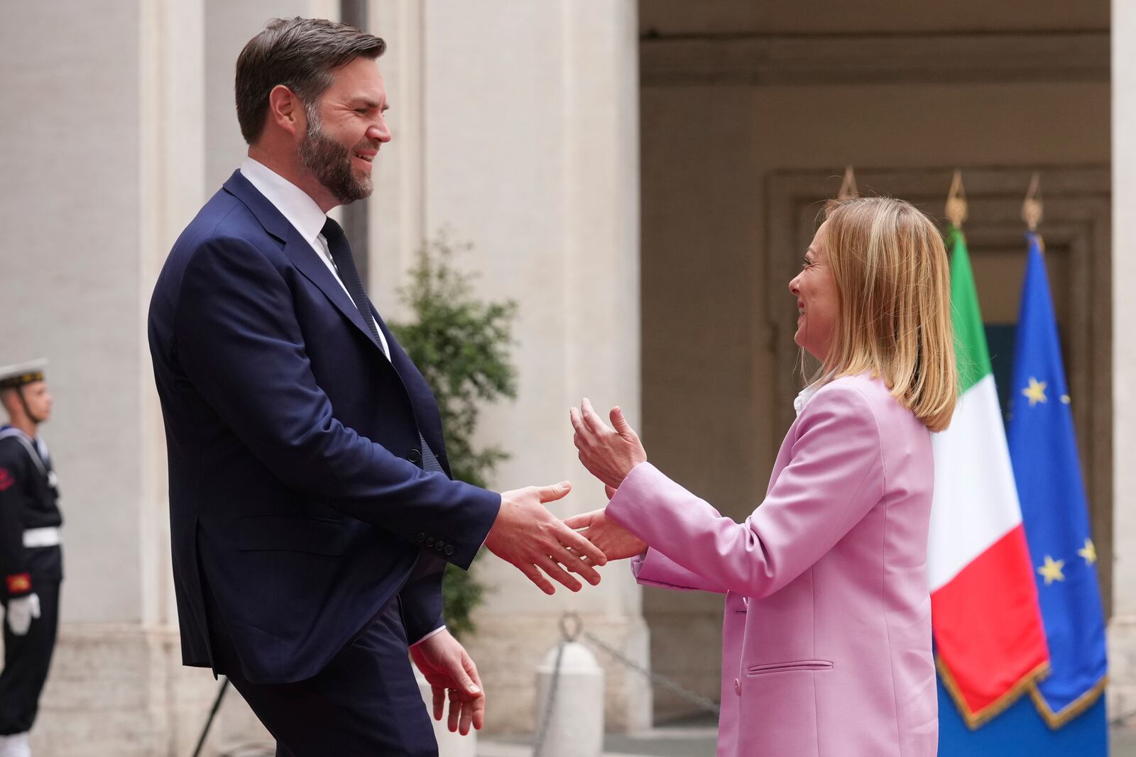 U.S. Vice President JD Vance, left, is welcomed by Italian Premier Giorgia Meloni as he arrives for talks at Palazzo Chigi government office in Rome, Friday, April 18, 2025. (AP Photo/Andrew Medichini)