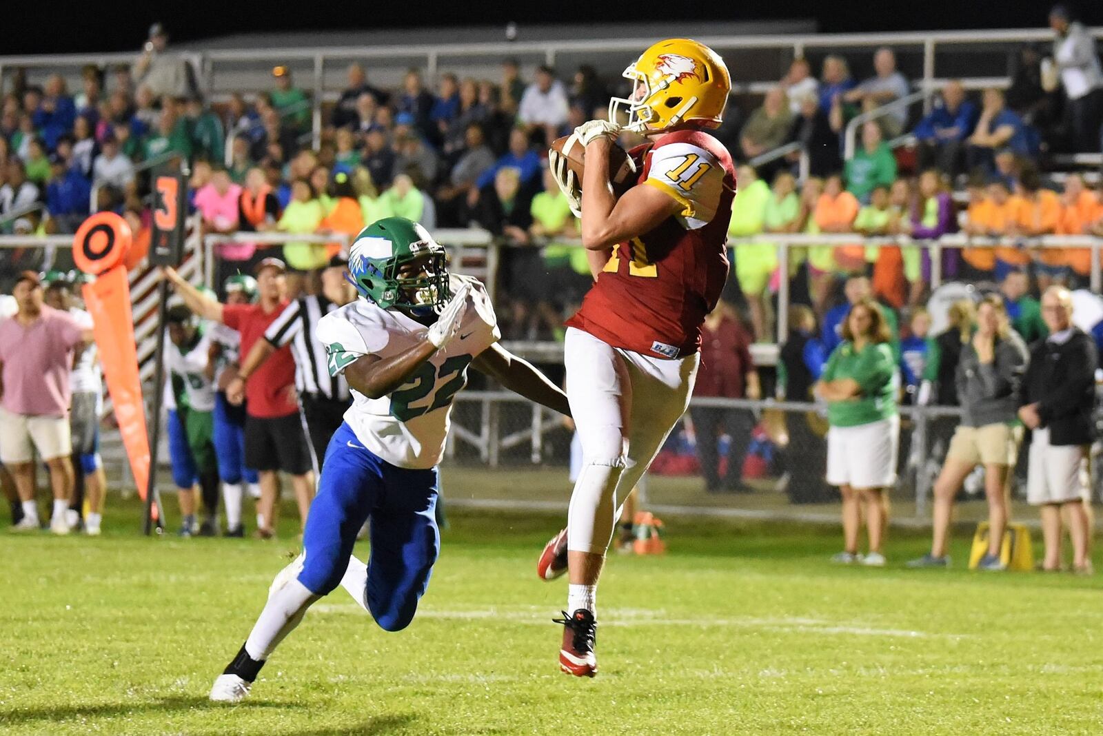 Fenwick’s Thomas Vogelsang (11) gets behind Chaminade Julienne’s Jason Ward (22) and catches a touchdown pass from Sully Janeck on Friday night as the Falcons recorded a 34-19 triumph. CONTRIBUTED PHOTO BY ANGIE MOHRHAUS