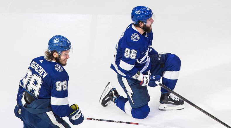 Tampa Bay Lightning's Mikhail Sergachev (98) and Nikita Kucherov (86) celebrate a goal against the New York Islanders during the third period of Game 2 of the NHL hockey Eastern Conference final, Wednesday, Sept. 9, 2020, in Edmonton, Alberta. (Jason Franson/The Canadian Press via AP)