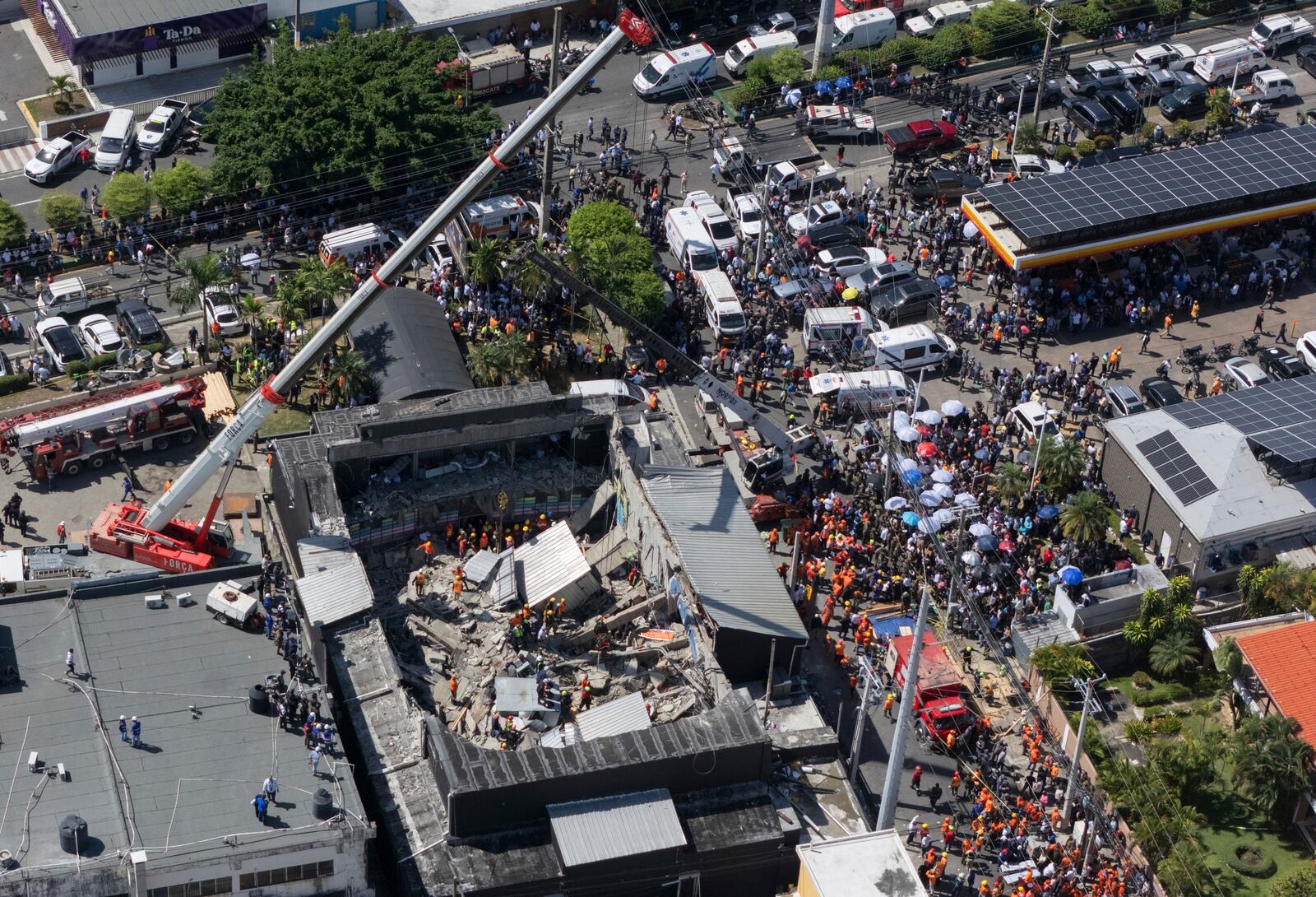 Rescue workers search for survivors at the Jet Set nightclub after its roof collapsed during a merengue concert in Santo Domingo, Dominican Republic, Tuesday, April 8, 2025. (AP Photo/Eddy Vittini)