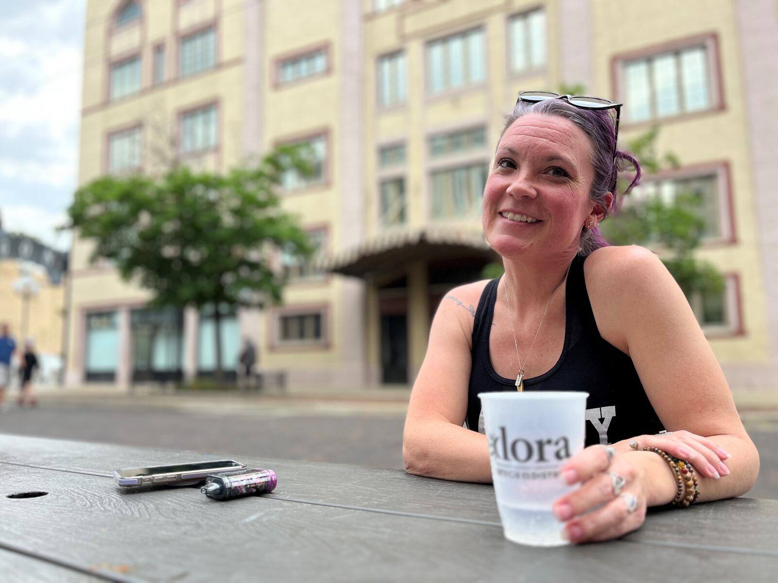 Kelly Tipton, 42, of Dayton, enjoys a drink in the Oregon District Designated Outdoor Refreshment Area (DORA) on Friday, May 19, 2023. CORNELIUS FROLIK / STAFF