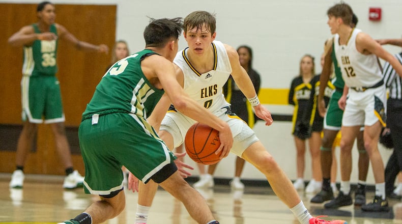 Centerville's Gabe Cupps defends during a game against Akron St. Vincent-St. Mary earlier this season. CONTRIBUTED/Jeff Gilbert