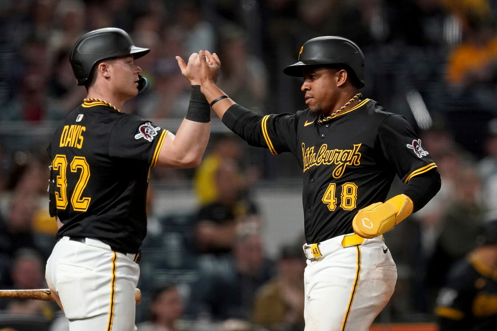 Pittsburgh Pirates' Enmanuel Valdez (48) is greeted by Henry Davis (32) after scoring during the eighth inning of a baseball game against the Washington Nationals, Monday, April 14, 2025, in Pittsburgh. (AP Photo/Matt Freed)