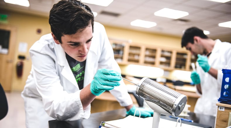 Human biology student Ryan Lafave works on how to utilize a piece of equipment in a laboratory at Kettering College. (Photo by Scott Robins)