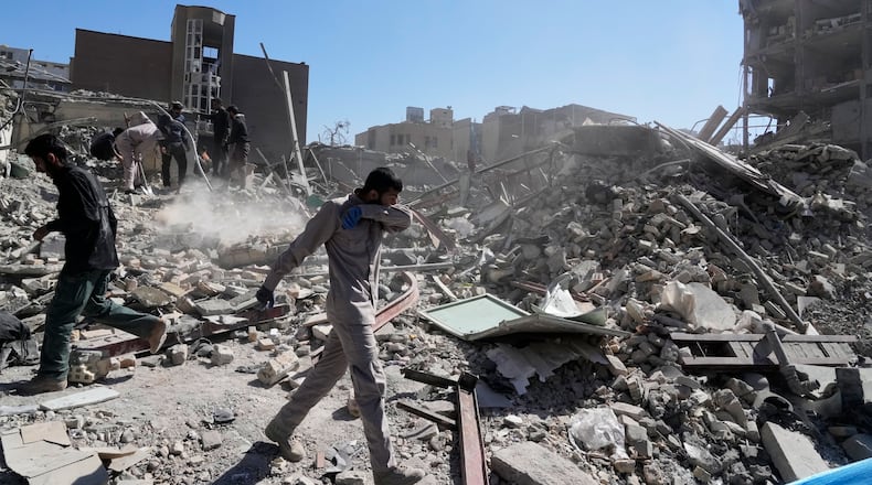 A group of men inspects the ruins of a police station struck Monday amid the U.S.–Israeli military campaign in Tehran, Iran, Tuesday, March 3, 2026. (AP Photo/Vahid Salemi)