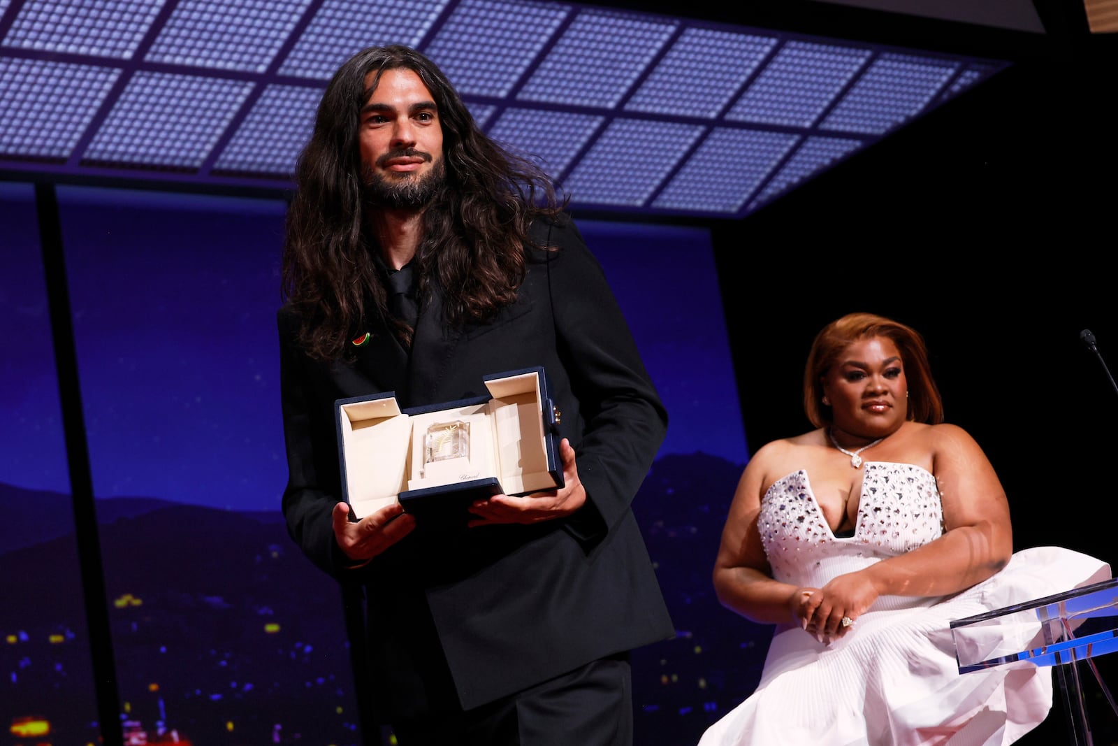 Director Oliver Laxe, left, accepts the jury prize for 'Sirat', presented by Da'Vine Joy Randolph, right, during the awards ceremony of the 78th international film festival, Cannes, southern France, Saturday, May 24, 2025. (Photo by Joel C Ryan/Invision/AP)