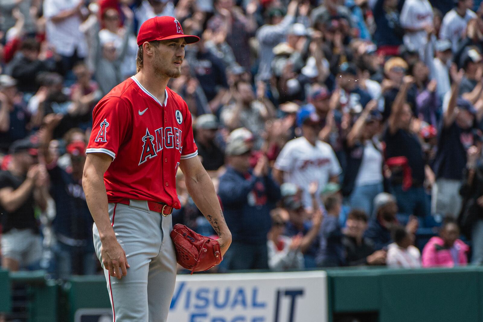 Los Angeles Angels starting pitcher Jack Kochanowciz watches as Cleveland Guardians' Jose Ramirez after a solo home run during the fourth inning of a baseball game, Sunday, June 1, 2025, in Cleveland. (AP Photo/Phil Long)