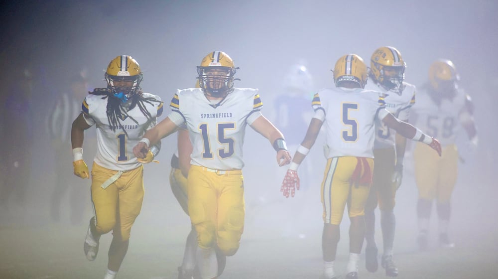 Springfield players, including Carter Bumgardner (15), celebrate a defensive stop against Springboro in the second round of the Division I, Region 2 playoffs on Friday, Nov. 7, 2025, at CareFlight Field in Springboro. David Jablonski/Staff