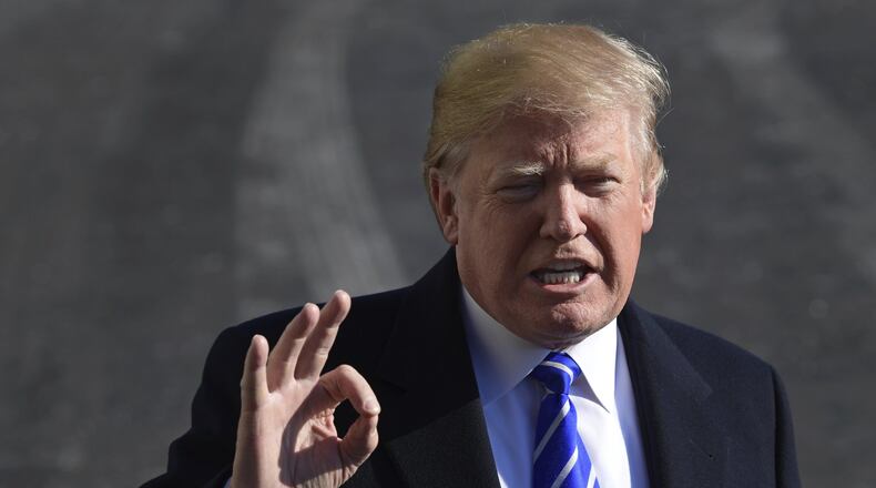 President Donald Trump talks with reporters as he departs from the South Lawn of the White House via Marine One in Washington, Saturday, Dec. 16, 2017, to spend the weekend at Camp David in Maryland. (AP Photo/Susan Walsh)