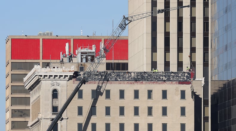Work continues at the building at 34 N. Main St., formerly the Key Bank Building or Paru Tower. During high winds on March 15, bricks in the upper part of the building next to Stratacache Tower fell into an alley. Some also hit Stratacache Tower and caused damage. The building is owned by the Montgomery County Land Bank and maintained by the city of Dayton. The city is hoping to have the building stabilized before the NATO assembly starts in later this month. Crews have been working to stabilize the former Key Bank Building, including as seen here on March 21. BRYANT BILLING / STAFF