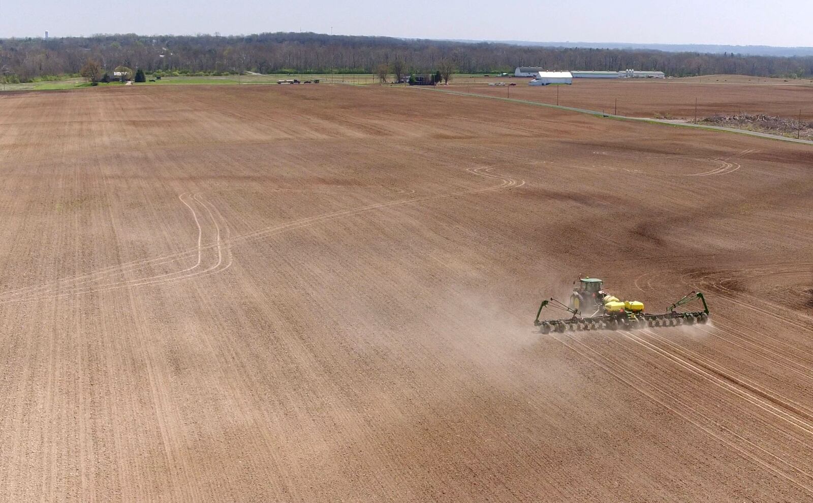 Spring planting is almost complete for most farmers in the Miami Valley.  Many have been conflicted about whether to plant corn or soybeans based on the uncertainty of trade tariffs.  This field along Dayton-Farmersville and Lutheran Church Roads had two tractors with grain drills planting.   TY GREENLEES / STAFF