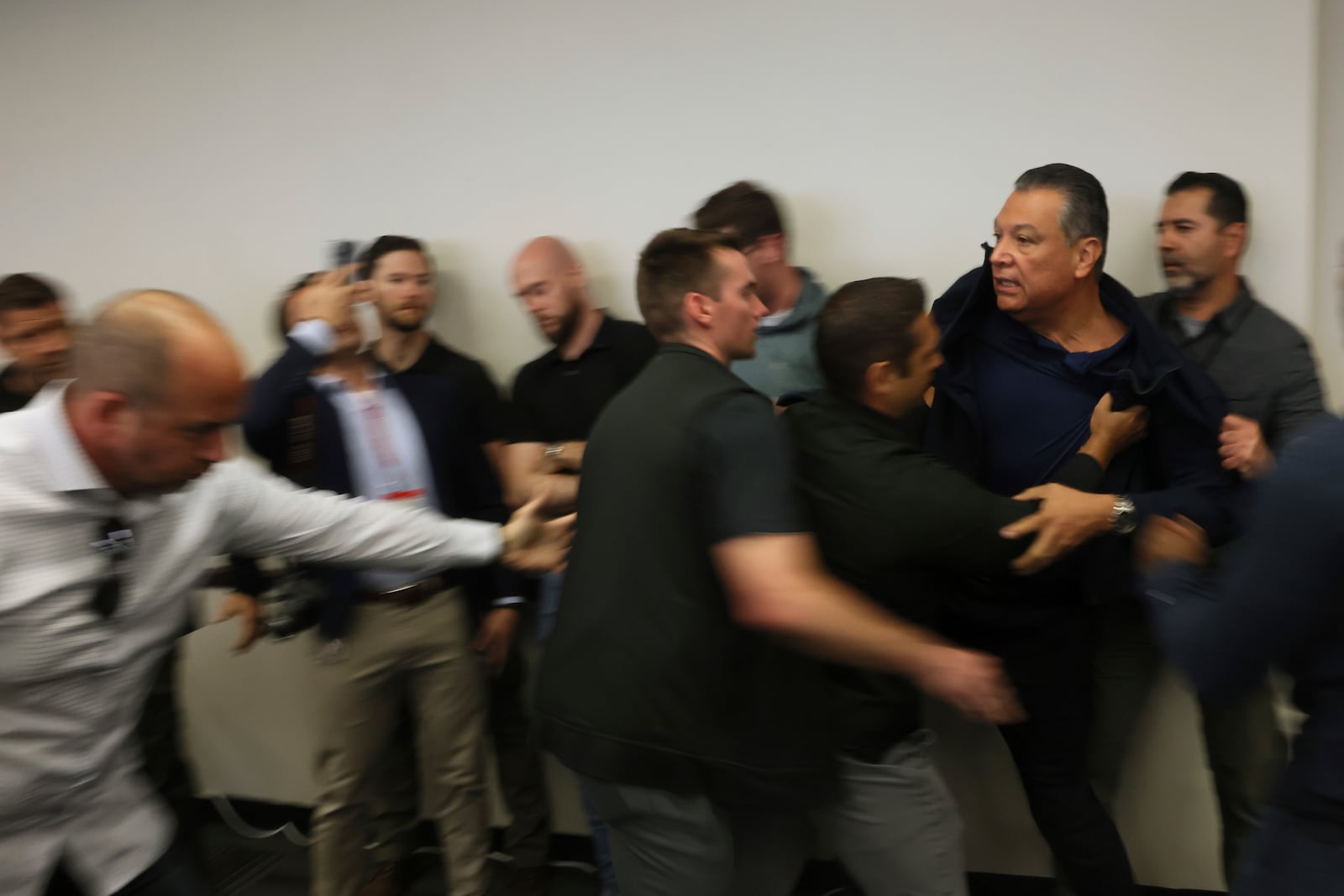 California Senator Alex Padilla is pushed out of the room as Noem holds a news conference regarding the recent protests in Los Angeles on Thursday, June 12, 2025. (AP Photo/Etienne Laurent)