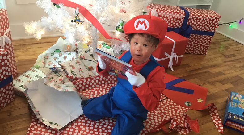 Matthew, one of the kids who was helped by a UD class this year, receiving a playset as part of his wish from the A Special Wish Dayton project. Contributed by David Seyer.