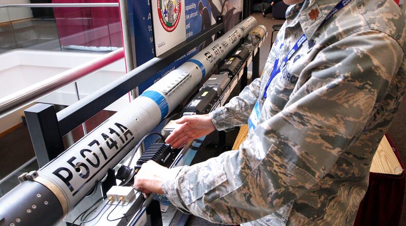 Air Force Maj. Thomas Adams displays the electronics of a new secure encrypted fighter pilot training system that integrates live fighter flights with pilots in simulators allowing them into the same virtual environment. The display was part of the AFRL Inspire Tech Expo at the Dayton Convention Center in May. WSARC, Wright State’s research arm, has won a $49 million Air Force contract to find new technologies in business and academia. TY GREENLEES
