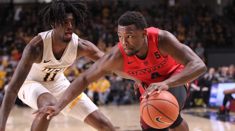 Dayton's Jordan Davis drives to the basket against Virginia Commonwealth's Isaac Vann on Saturday, Feb. 10, 2018, at the Siegel Center in Richmond, Va.