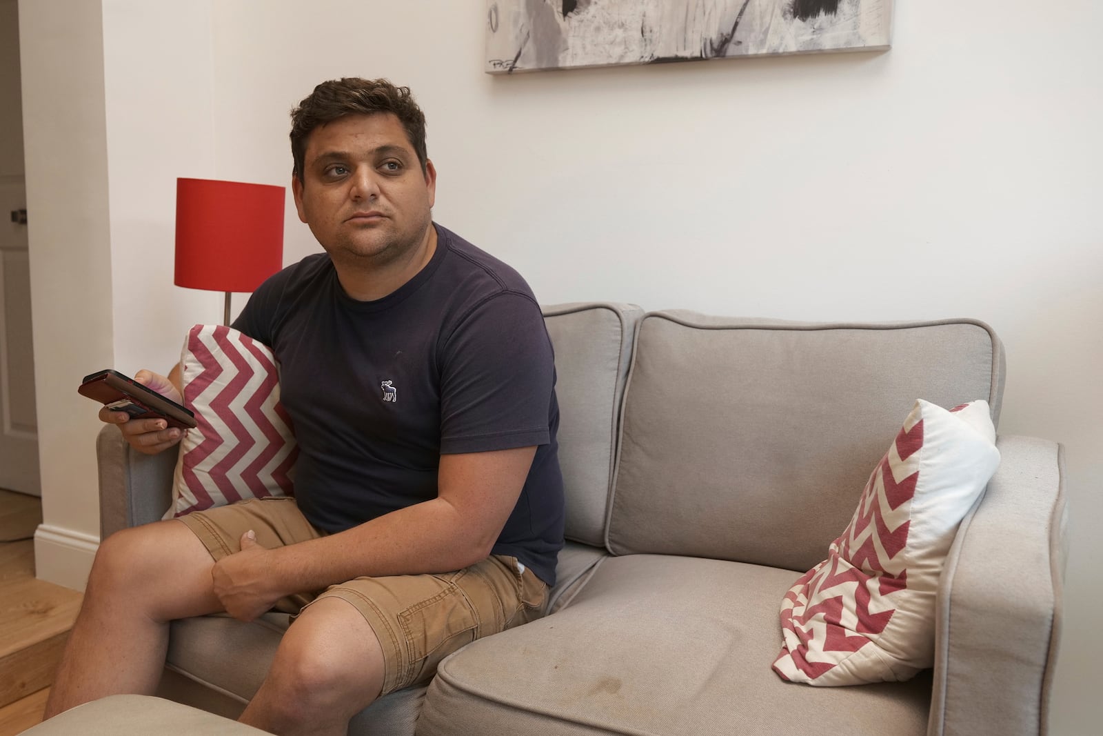 Spencer Goidel, an Equal Employment Opportunity Specialist with the Internal Revenue Service who was notified his job would be eliminated as part of the government's efficiency cuts, sits for a portrait in his home in Boca Raton, Fla., April 16, 2025. (AP Photo/Daniel Kozin)