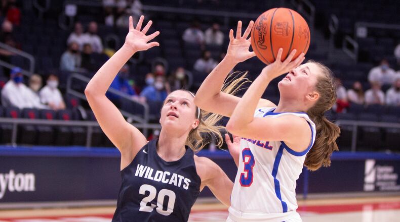 Carroll's Sarah Ochs puts up a shot against Napoleon's Taylor Strock during a Division II state semifinal game at UD Arena on Friday, March 12, 2021. Jeff Gilbert/CONTRIBUTED