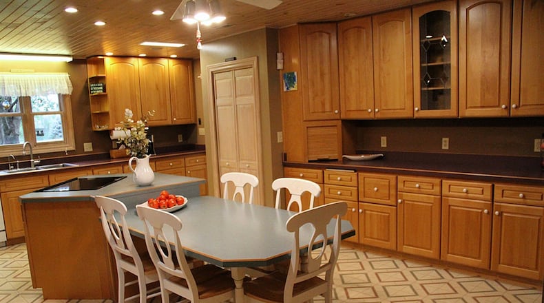The current kitchen was created by renovating and combining the 2 rooms that held the original kitchen and a separate summer kitchen. Knotty pine was used to panel the ceiling, and recessed ceiling lights were installed.