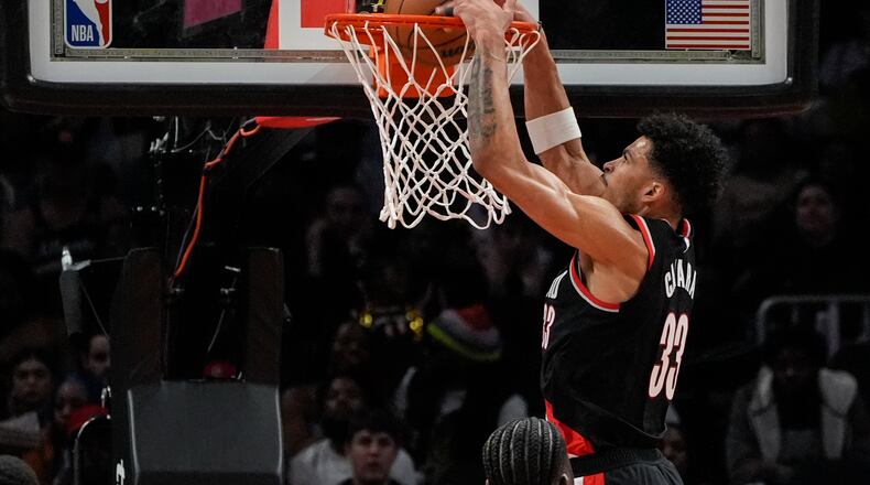 Portland Trail Blazers forward Toumani Camara (33) scores against the Atlanta Hawks during the first half of an NBA basketball game Wednesday, March 27, 2024, in Atlanta. (AP Photo/John Bazemore)