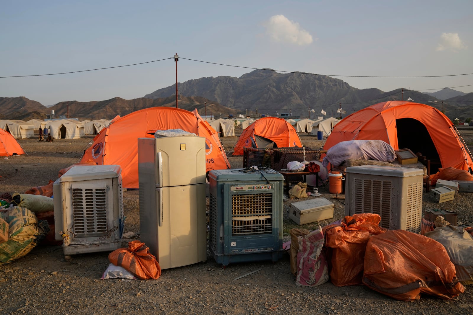 Household belongings of a refugee family repatriated from Pakistan sit at a camp housing Afghan refugees at the Pakistan-Afghanistan border in Torkham, Afghanistan, Saturday, May 31, 2025. (AP Photo/Ebrahim Noroozi)