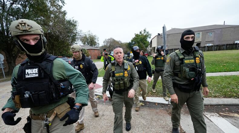FILE - Customs and Border Patrol commander Gregory Bovino walks with border patrol agents through a neighborhood during an immigration crackdown, in Kenner, La., Dec. 5, 2025. (AP Photo/Gerald Herbert, File)