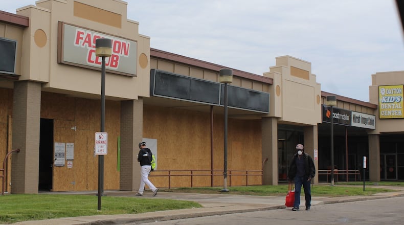 A construction worker and pedestrian walk by what will be a new primary care medical clinic in the Westown Shopping Center. Oak Street Health is opening a new facility that serves Medicare patients. CORNELIUS FROLIK / STAFF