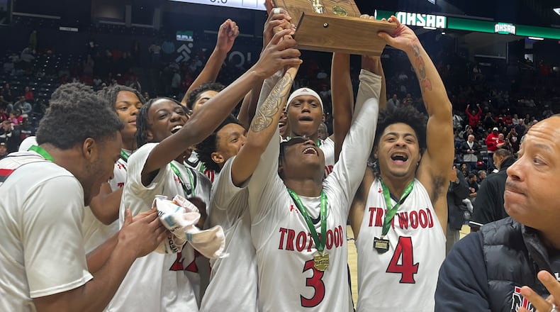The Trotwood-Madison High School boys basketball team lifts the trophy after beating Hamilton Badin in the Division III, Region 12 championship game on Saturday, March 14, 2026 at Xavier University's Cintas Center. GEOFF NEVILLE / CONTRIBUTED PHOTO