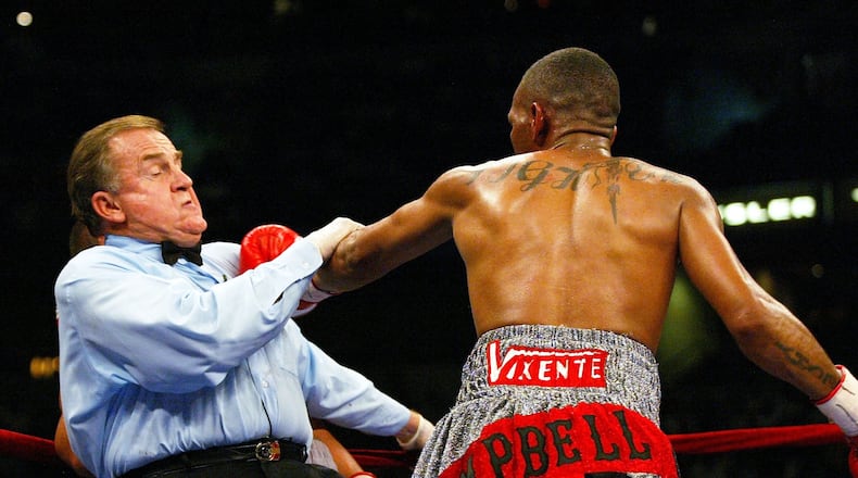 TAMPA, FL - OCTOBER 1: Referee Brian Garry takes a punch after stepping between Almazbek Raiymkulov and Nate Campbell (R) in a Lightweight bout at the St. Pete Times Forum on October 1, 2005 in Tampa, Florida. (Photo by Doug Benc/Getty Images)